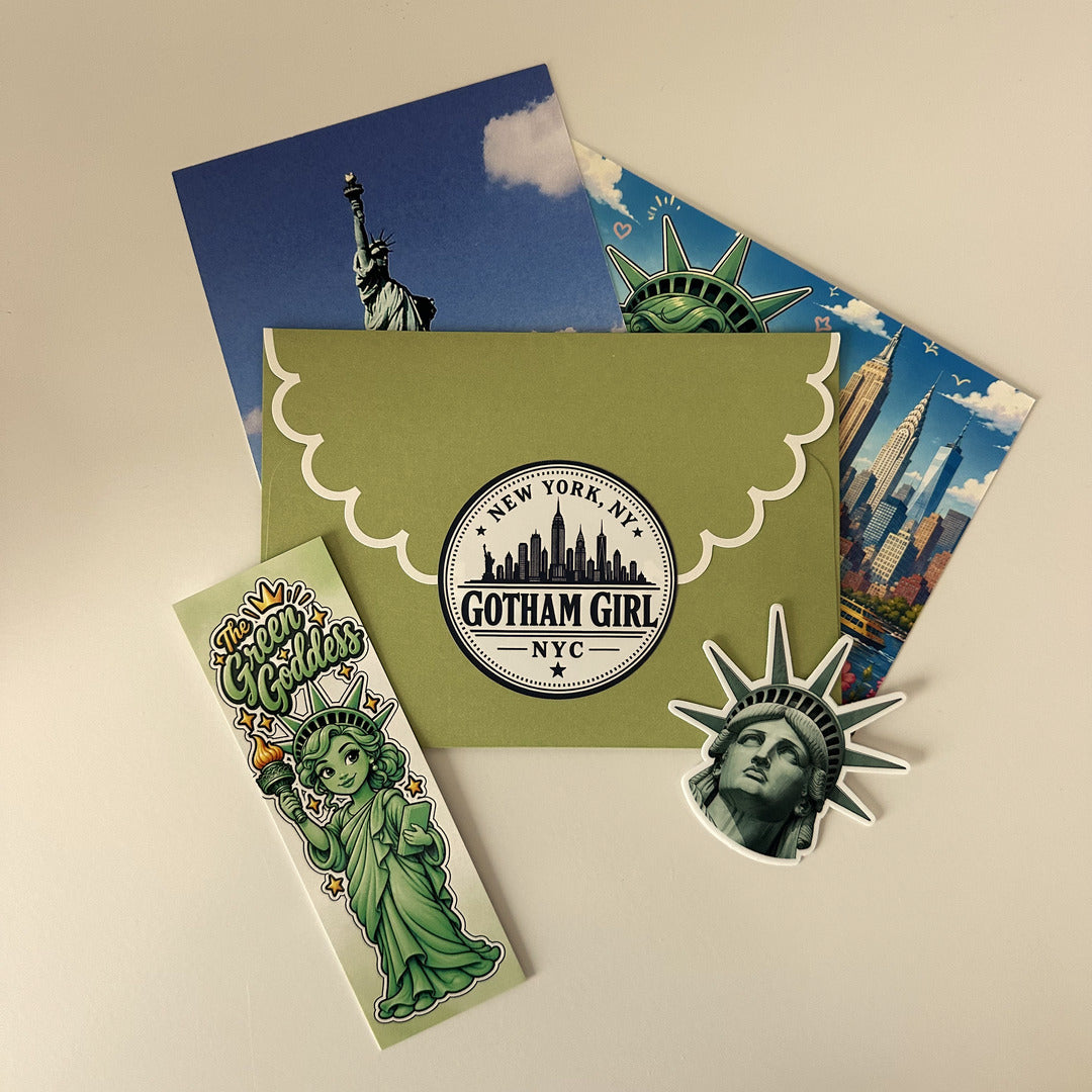 The October 2026 Gotham Girl envelope with its Statue of Liberty photo, illustrated New York postcard, Green Goddess bookmark and Liberty sticker